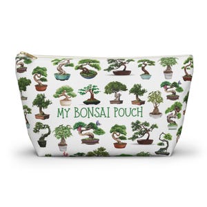 May include: White zippered pouch with a repeating pattern of bonsai trees in various pots. The text "MY BONSAI POUCH" is printed in green letters in the center of the pouch.