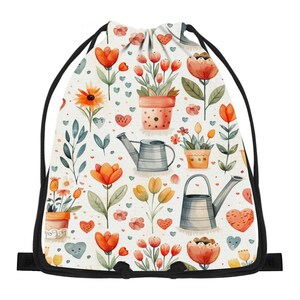 May include: A drawstring backpack featuring a white background with a repeating pattern of orange and yellow flowers in terracotta pots, gray metal watering cans, and small red and blue hearts. The bag has black cord straps.