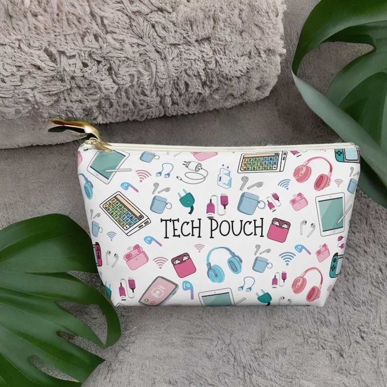 May include: White zippered pouch with a colorful pattern of tech accessories, including headphones, charging cables, and a tablet. The pouch has the text "TECH POUCH" printed on it.