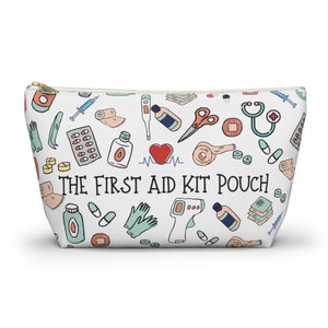 May include: White zippered pouch with a colorful pattern of first aid items, including bandages, pills, a stethoscope, and a thermometer. The text "THE FIRST AID KIT POUCH" is printed in black on the front.