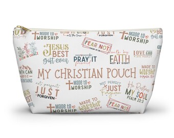 May include: White zippered pouch with a colorful pattern of Christian-themed phrases and scripture verses. The pouch features phrases like "Made to Worship", "Jesus Best Gift Ever", "Fear Not", "Just Forgiven", and "Pray It Forward".