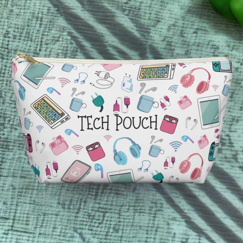 May include: White zippered pouch with a repeating pattern of tech accessories, including headphones, charging cables, and smart devices. The pouch has the text "TECH POUCH" printed on the front.