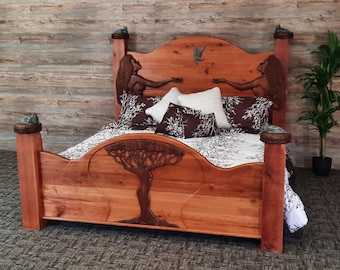 May include: A wooden bed frame with a carved tree design and two figures on the headboard. The bed is made of natural wood and has a rustic look. The bed is covered in a white and black patterned bedding.