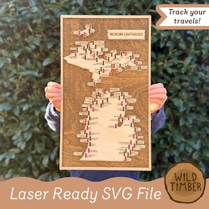 May include: Wooden map of Michigan with laser-cut lighthouse markers. The map is framed in a dark wood, with the text "MICHIGAN LIGHTHOUSES" at the top. The phrase "Track your travels!" is in a banner. The words "Laser Ready SVG File" are at the bottom.