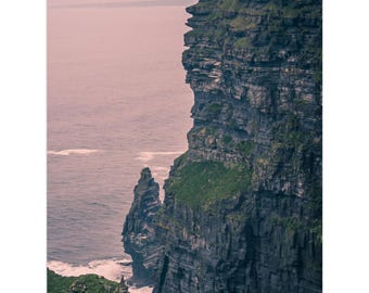 May include: A calendar featuring a scenic view of a coastal cliff with the ocean in the background. The cliff is dark green and gray, with the text "2026-2027" at the bottom. The calendar has a spiral binding at the top.