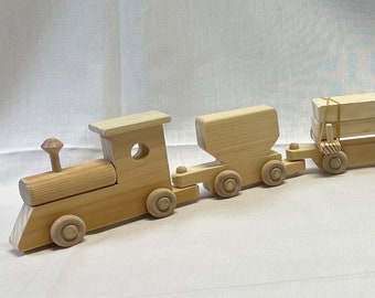 May include: A wooden toy train set with a locomotive, a boxcar, a tanker car, a flatbed car, and a caboose. The train is made of natural wood and has a rustic, vintage look.