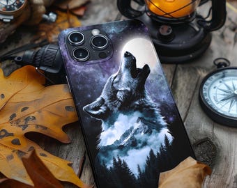 May include: A black phone case with a wolf howling at the moon. The wolf is silhouetted against a starry sky and a mountain range. The phone case has a camera lens cutout and a white moon graphic.