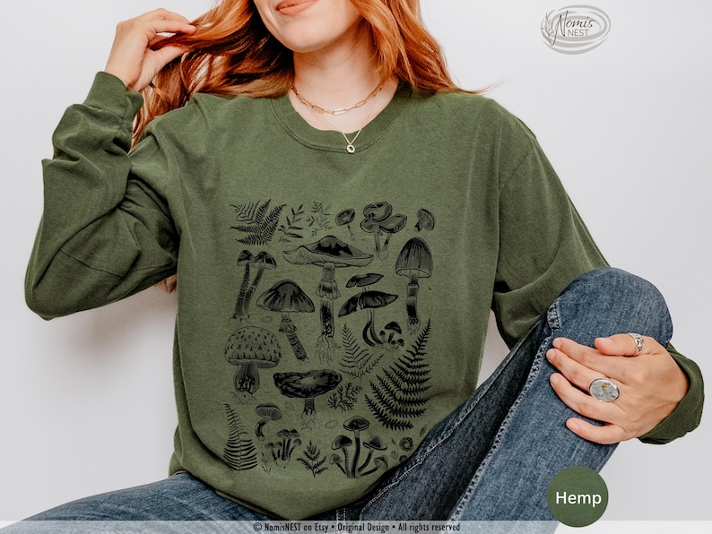A hemp colored Comfort Colors long sleeve mushroom graphic t-shirt featuring illustrated botanical mushrooms which is perfect for granola girls, mushroom fans, those seeking a forestcore aesthetic, or nature lovers.