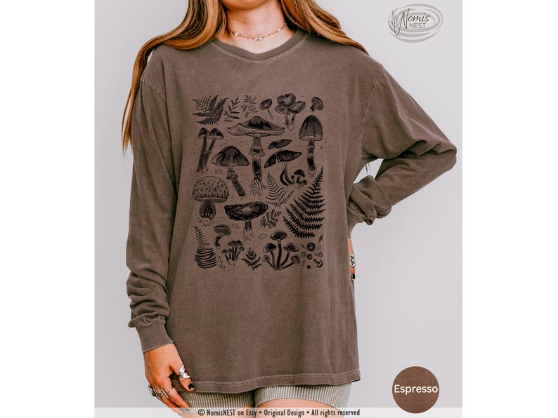 An espresso colored Comfort Colors long sleeve mushroom graphic t-shirt featuring illustrated botanical mushrooms which is perfect for granola girls, mushroom fans, those seeking a forestcore aesthetic, or nature lovers.