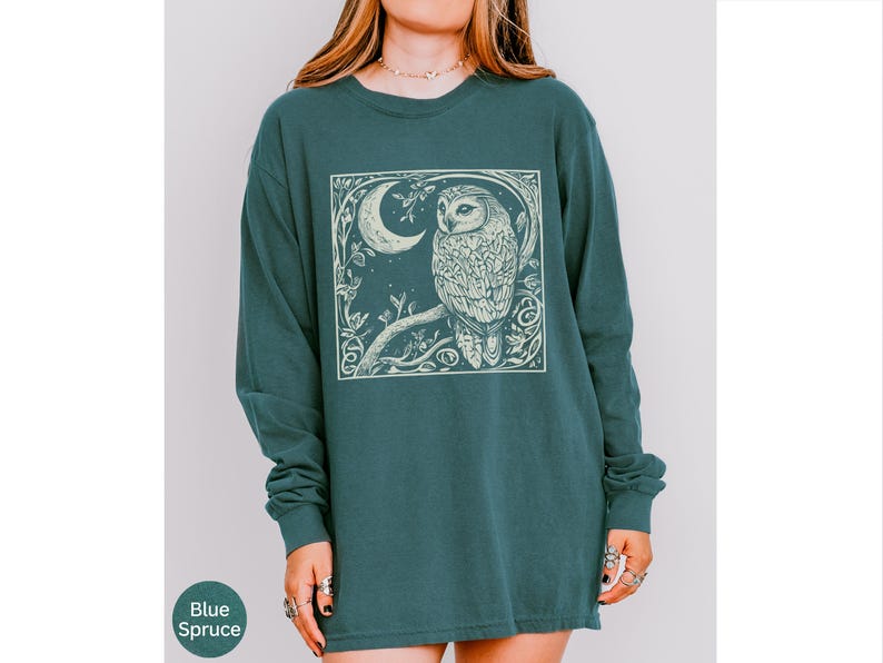 A long sleeve Comfort Colors graphic t-shirt with a linocut style Snowy Owl evoking a witchy, magical, & Dark Academia vibe.