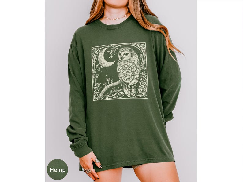 A long sleeve Comfort Colors graphic t-shirt with a linocut style Snowy Owl evoking a witchy, magical, & Dark Academia vibe.