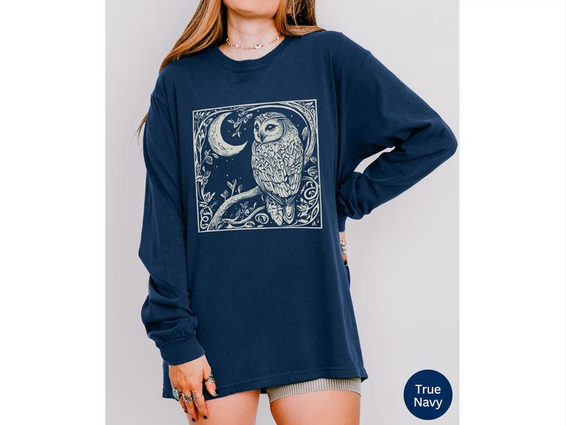 A long sleeve Comfort Colors graphic t-shirt with a linocut style Snowy Owl evoking a witchy, magical, & Dark Academia vibe.