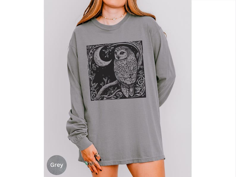 A long sleeve Comfort Colors graphic t-shirt with a linocut style Snowy Owl evoking a witchy, magical, & Dark Academia vibe.