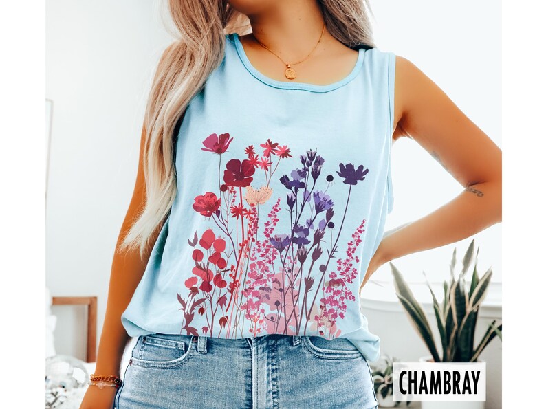 A model is wearing a Comfort Colors tank top with pressed wildflowers in a mix of reds, berries, and pastel colors.