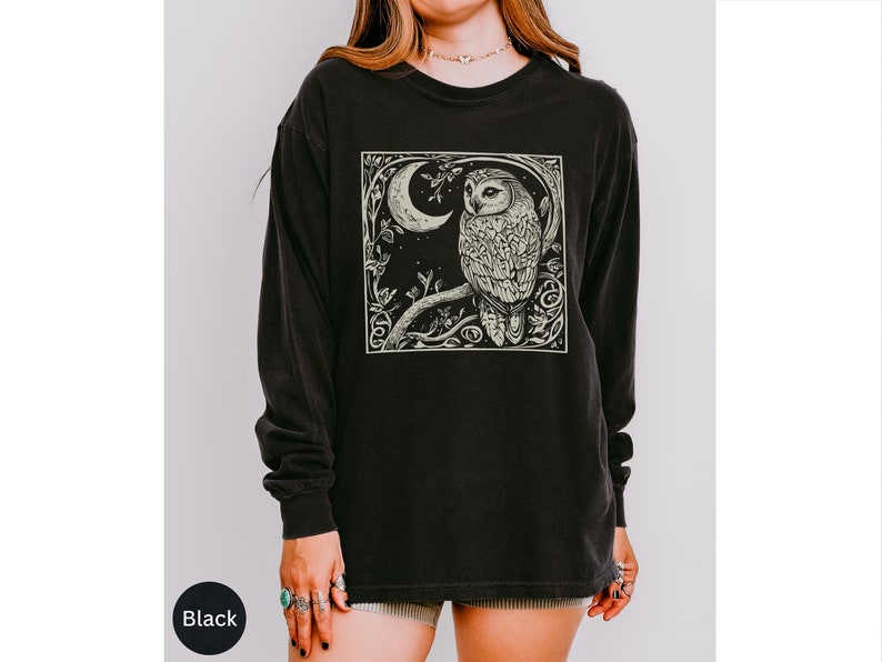 A long sleeve Comfort Colors graphic t-shirt with a linocut style Snowy Owl evoking a witchy, magical, & Dark Academia vibe.