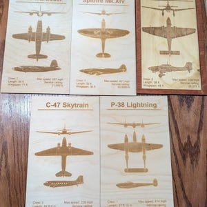 May include: Wooden plaques with engraved illustrations of vintage airplanes, including the B-26 Marauder, Spitfire Mk.XIV, Junkers Ju87, C-47 Skytrain, and P-38 Lightning. Each plaque features top, side, and bottom views, along with specifications.