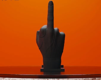 May include: A 3D printed model of a hand giving the middle finger. The hand is black and has stitches on the back. The hand is on a small black base. The text .STL Digital Dowload for 3D Printing is at the top of the image.