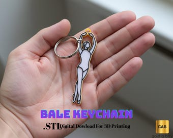Puede incluir: Un llavero con diseño de bailarina, blanco con contornos negros y detalles amarillos, con un llavero plateado. El texto "BALE KEYCHAIN" y ".STL Digital Download For 3D Printing" son visibles.