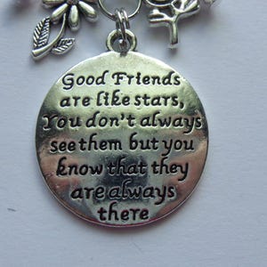 May include: Silver charm with the quote "Good Friends are like stars, You don't always see them but you know that they are always there".