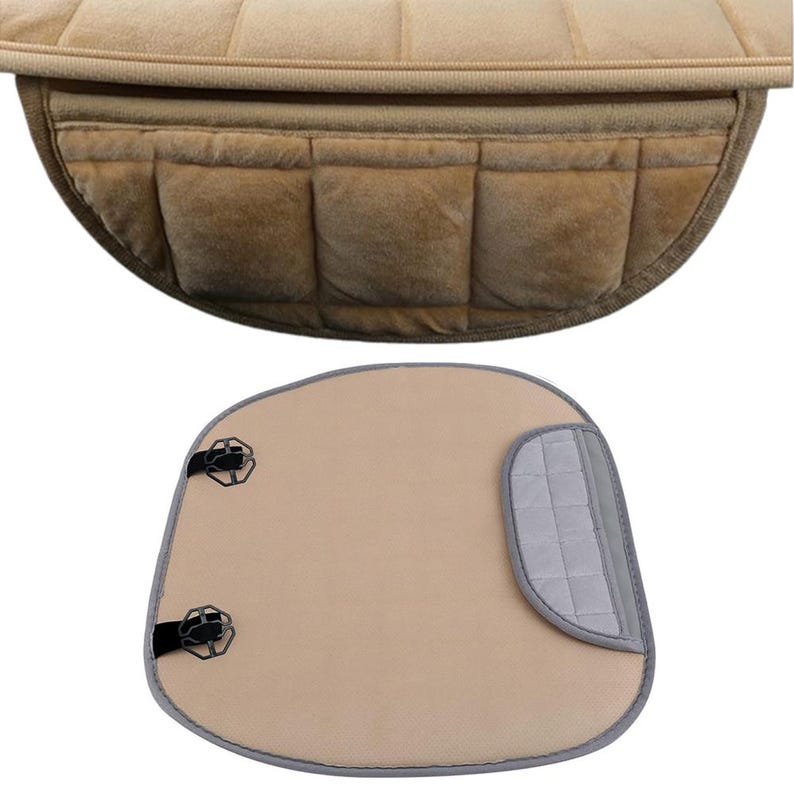 May include: A beige car seat cushion with a grey strap and two black clips. The cushion is made of a soft, plush material and has a quilted design.