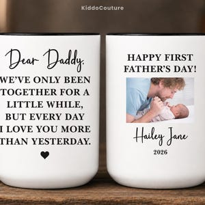 May include: White ceramic mug with black handle and rim. The mug features the text "Dear Daddy" and a heartfelt message. The other side of the mug has a photo, the text "Happy First Father's Day!" and the name "Hailey Jane" and the year 2026.