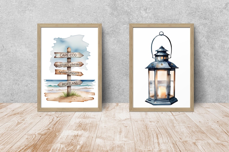 May include: Two framed wall art prints in light wood frames. The left print features a watercolor signpost with the text Cape Cod, Martha's Vineyard, Narragansett, and Portland on a beach. The right print shows a dark metal lantern with a lit candle.