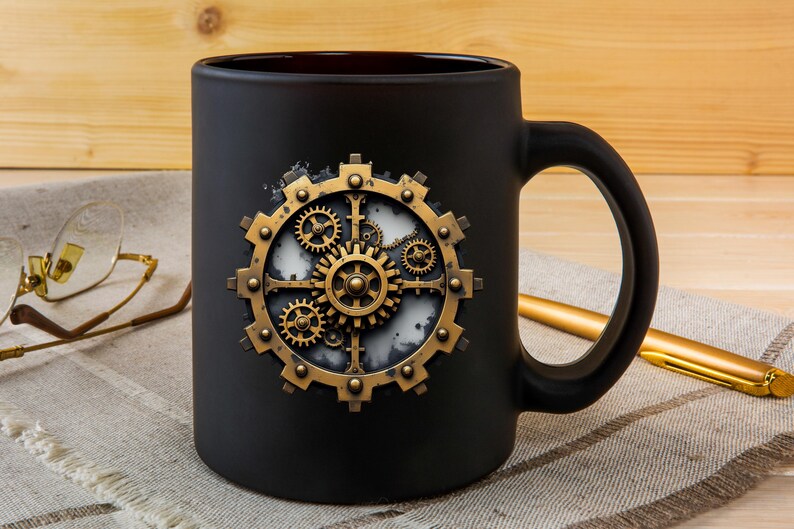 May include: Black ceramic mug featuring a steampunk-style gear design in gold and bronze tones. The gear design is centered on the mug, with intricate details. The mug has a curved handle and is set against a neutral background.