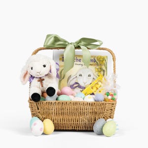 May include: A woven wicker Easter basket filled with a plush lamb, a book, and colorful Easter eggs. The basket is tied with a green satin ribbon. The basket contains a variety of candies and treats.
