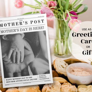 May include: A black and white newspaper-style card with the text "The Mother's Post" and "Mother's Day is Here!"  The card features a photo of hands, one adult and one child, with the text "Happy Mother's Day to the Best Mom Anyone Could Ask For!"  The card is on a table with a plate of food and a vase of pink flowers.