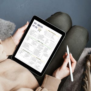 May include: A digital tablet displaying a birth plan template titled "MY BIRTH PLAN". The template includes sections for personal information, labor and delivery preferences, and newborn care. A white stylus is held in the hand, ready to make notes on the tablet.