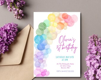 May include: A colorful invitation with a rainbow of watercolor circles. The text reads "Olivia's 1st birthday" with the date and time of the party. The invitation also includes the address and RSVP information.