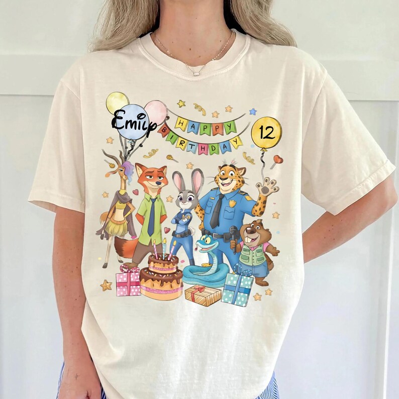 K&ouml;nnte beinhalten: Eine wei&szlig;e Keramik-Tasse mit schwarzem Henkel und dem Text "But First, Coffee" in fetter, schwarzer Schrift. Die Tasse steht vor einem verschwommenen Hintergrund, der eine gem&uuml;tliche Umgebung suggeriert.