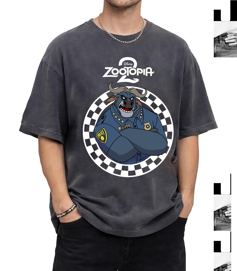 May include: Dark grey Zootopia 2 t-shirt with a cartoon bull character in a police uniform inside a chequered circle. The Disney logo is above the character. The shirt has short sleeves and a relaxed fit.