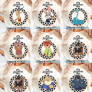 May include: Cream-coloured t-shirts featuring characters from the animated film "Zootopia." Each shirt displays a different character inside a black and white chequered circle, with the film's logo at the top. Characters include a gazelle, rabbit, snake, and others.