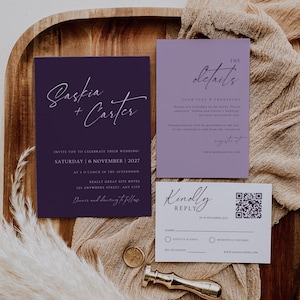 May include: A white ceramic mug with a black handle and the text "But First, Coffee" in a bold, black font. The mug is set against a blurred background, suggesting a cosy setting.