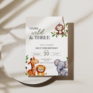 May include: A birthday invitation with a jungle theme. The text reads "Young, Wild & Three" above the invitation details. The invitation features illustrations of a giraffe, lion, elephant, and monkey. The date is August 30th.