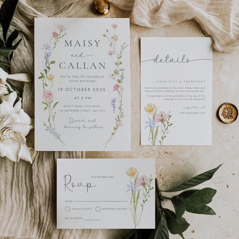 May include: Wedding invitation suite with floral designs. The main invitation card features a wreath of watercolor flowers and the text "Maisy and Callan invite you to celebrate their wedding! 19 October 2025 at 2 PM Really Great Site Hotel 125 Anywhere Street, Any City Dinner and dancing to follow". The details card has the text "Your Stay & Transport Rooms are available at the hotel. Please reference "Maisy & Callan wedding" for your discounted rate. Transportation will be provided from the day of the wedding to and from the reception. Register at www.maisyancallan.com". The RSVP card has the text "RSVP by 16 September 2025 Names Joyfully Accepts Regretfully Declines No. of Guests".