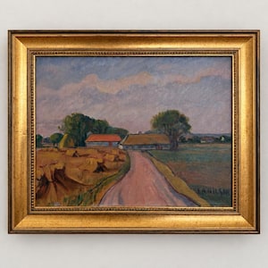 May include: An oil painting in a gold frame depicting a rural landscape with a dirt road leading toward a house with a thatched roof. The scene includes golden haystacks in a field, green trees, and a cloudy blue sky. The artist signature E.A. NILSON is visible.