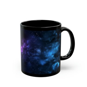 May include: Black coffee mug with a galaxy print featuring blue, purple, and white nebulae and stars.