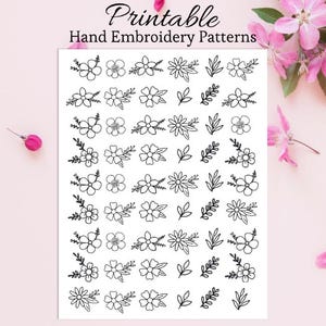May include: A white sheet with black line art floral and leaf embroidery patterns. The text "Printable Hand Embroidery Patterns" is at the top. Pink flowers and buds are in the background.