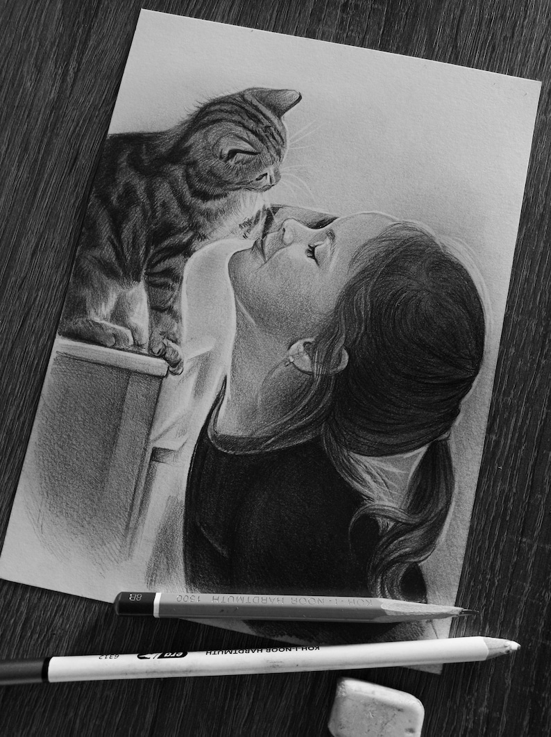 May include: A graphite pencil drawing on paper depicting a person with their hair in a ponytail looking at a tabby cat. The cat is perched on a ledge. Two Koh-I-Noor Hardtmuth pencils and a white eraser are positioned below the drawing.