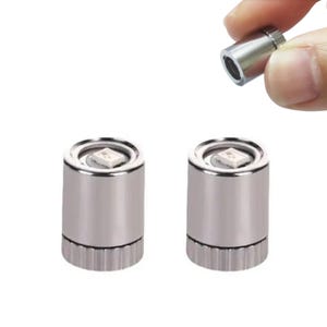 May include: Three small, cylindrical silver LED lights. Two lights are upright, and one is held by a person's fingers. Each light has a ridged base and a square, white LED at the top. The lights are designed for various applications.