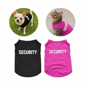 May include: A Chihuahua and a cat wearing "SECURITY" shirts. The dog is in a black shirt, and the cat is in a pink shirt. Two additional shirts, one black and one pink, are also displayed, each with the word "SECURITY" in white.
