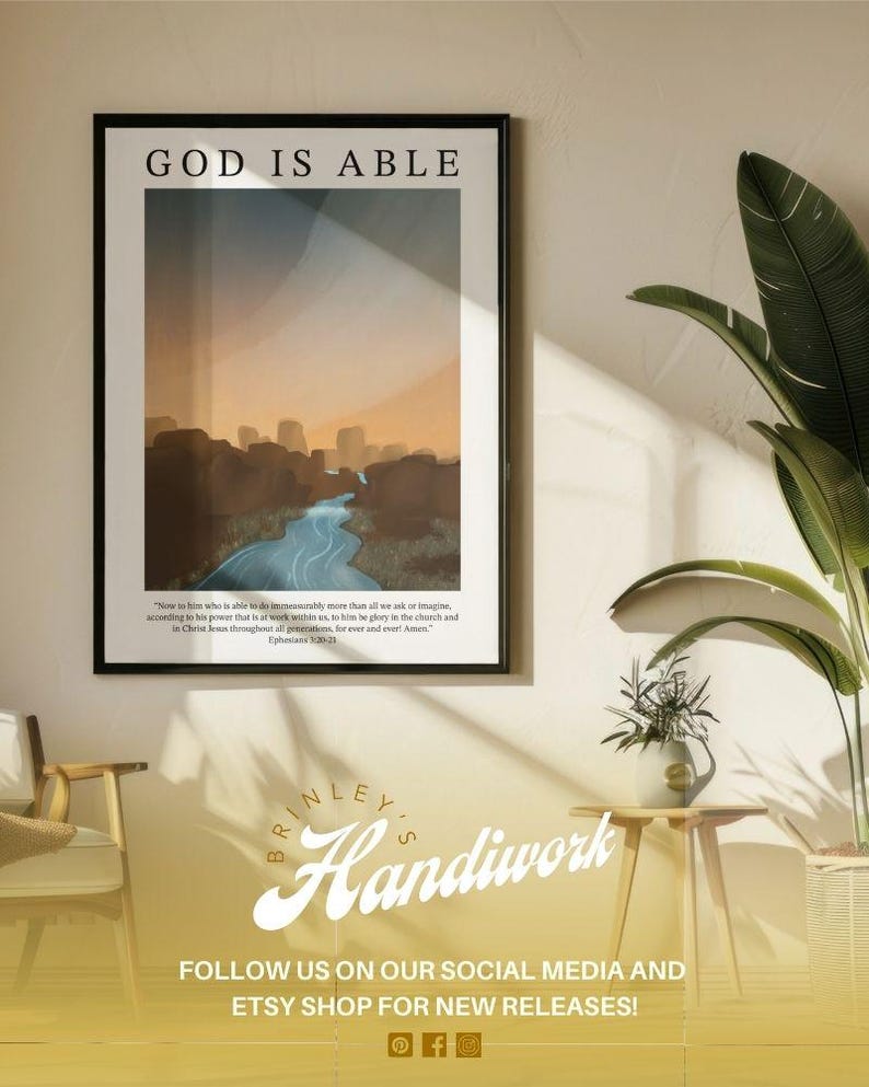 May include: Framed art print with the text "GOD IS ABLE" above a landscape illustration featuring a river and mountains. The print includes a Bible verse and the artist's name, "BRINLEY'S Handiwork", with social media information.