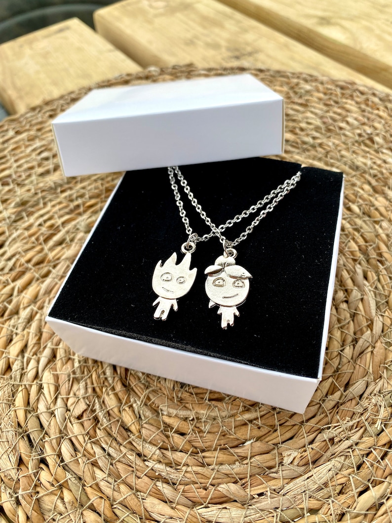 Introducing the Friendship Necklace: two silver stainless steel pieces, one fire-shaped and the other like water. Each distinct, they symbolize unity in diversity, perfect for friends who complement each other.