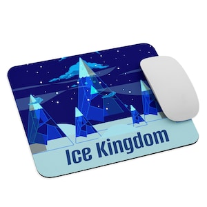 May include: A rectangular mousepad featuring a stylized illustration of an ice kingdom with blue mountains, clouds, and a starry night sky. The text "Ice Kingdom" is at the bottom. A white mouse is on the right.