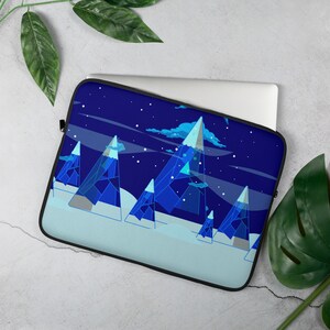 May include: Laptop sleeve featuring a geometric mountain range design in shades of blue and white against a dark blue starry sky. The sleeve has a black zipper and is designed to protect a laptop.