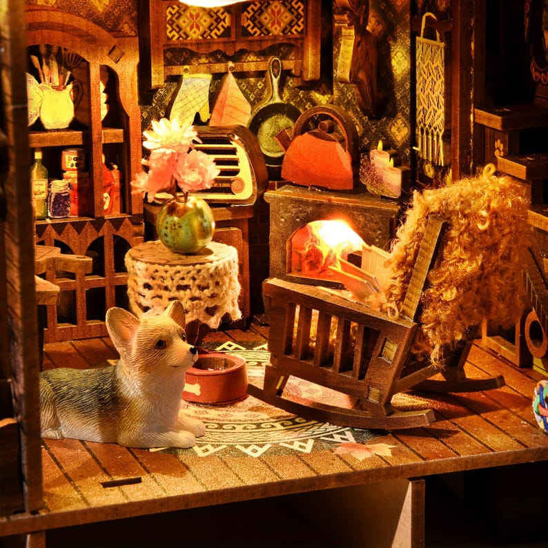 May include: A miniature wooden dollhouse interior with a cozy, rustic theme. Features include a fireplace with a glowing fire, a rocking chair, and a small corgi figurine. The scene is filled with detailed miniature furniture and decor.