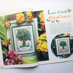 May include: A magazine page with a cross-stitch pattern of a tree with a banner that reads "Primavera". The page is surrounded by sunflowers, butterflies, and a floral arrangement. The text "Las Cuatro Estaciones" is at the top of the page.