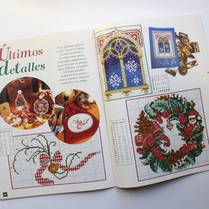 May include: A magazine page with a title that reads "&Uacute;ltimos detalles" and features several cross-stitch patterns. The patterns include a Christmas wreath, a window with snowflakes, and a Christmas tree ornament.